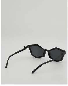 Detail view of matte black geometric sunglasses with sharp polygonal frame and grey lenses