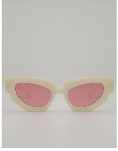 Close-up of cream white cat-eye sunglasses with geometric frame and pale pink lenses