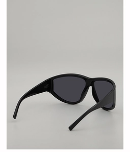 Detail view of oversized sporty sunglasses with glossy black frames and dark grey lenses