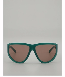 Front view of oversized green resin sunglasses with dark brown lenses for fashion