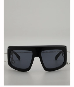 Detail of square oversized Y2K sunglasses with silver metal chain and dark lenses