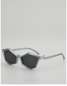 Detail view of silver geometric sunglasses with matte frame and lightning-shaped temples