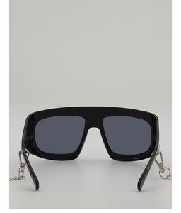 Detail of stylish oversized Y2K sunglasses with black frame and detachable metal chain