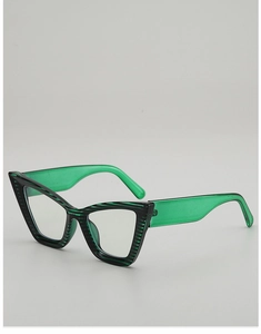 Detail of green cat-eye sunglasses with black striped frames and translucent temples