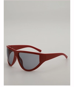 Close-up of oversized retro red shield sunglasses with thick frames and grey lenses
