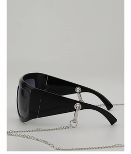 Close-up of black oversized Y2K sunglasses with silver metal chain detailing