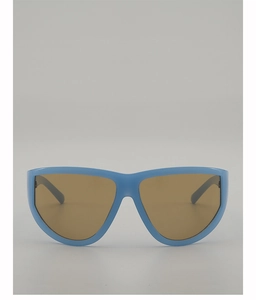 Detail of oversized light blue sunglasses frame with semi-transparent brown lenses