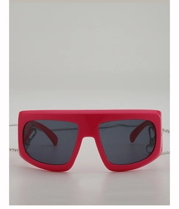 Hot pink oversized Y2K sunglasses with dark grey lenses and a silver metal chain detail
