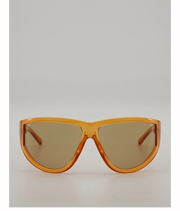 Front view of oversized amber translucent frame sunglasses with brown shaded lenses