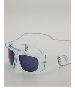 Detail of light blue Y2K sunglasses with purple lenses and a silver metal chain accessory