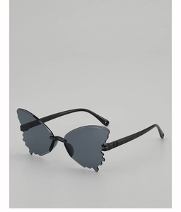 Detailed view of butterfly-shaped kids sunglasses with wavy edges and dark lenses