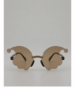 Detail of funny clown party glasses with wavy brown lenses and decorative pom-pom tips