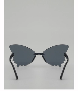 Detail view of butterfly-shaped rimless sunglasses for kids with grey lenses and black arms