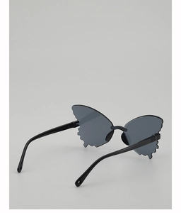 Detail view of butterfly shaped rimless sunglasses with dark grey lenses and black temples