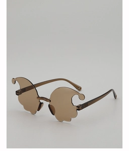 Detailed view of wavy-edged brown ghost-shaped frameless glasses for party selfies