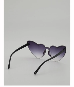 Detail of trendy heart-shaped sunglasses with purple gradient lenses and black temples
