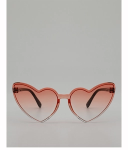 Detail of pink translucent heart-shaped sunglasses with gradient lenses for kids