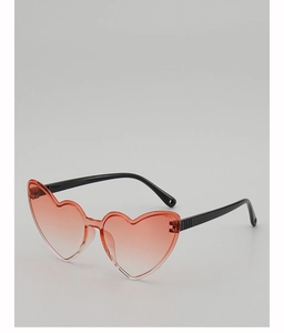 Flat lay of heart-shaped rimless sunglasses with pink gradient lenses and black temples