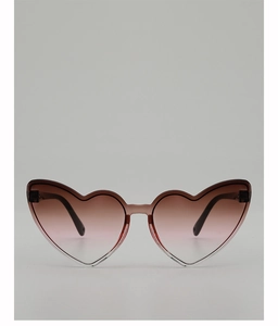 Detail view of heart-shaped gradient sunglasses with translucent light brown frames