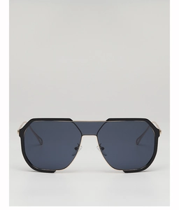 Detail of modern oversized sunglasses with black frame, gold bridge and dark lenses