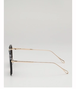 Detail of black frame sunglasses with golden metal temples and teardrop cutout tips