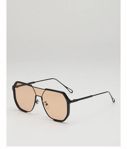 Detail view of large geometric black frame sunglasses with amber lenses and metal temples