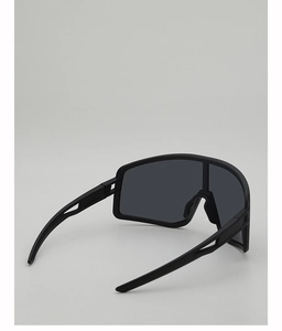 Detail of matte black cycling glasses featuring side vents and anti-fog wrap lens