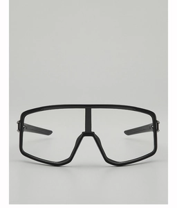 Close-up of black cycling glasses with adjustable nose pads and clear lens for wind protection