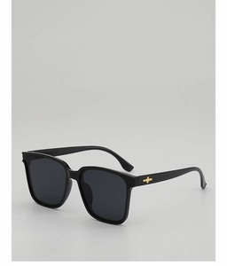 Detail of square black sunglasses with golden star metal accents on the temple