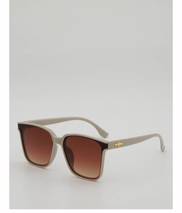 Detail of square beige frame sunglasses showing golden cross metal hinge and size marking