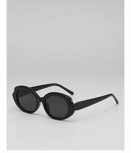 Detail shot of vintage black oval sunglasses with high-gloss thick frames and dark lenses