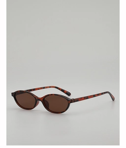 Makro-Detail der Retro-Sonnenbrille mit ovalem Leopardenmuster und braunen Gläsern