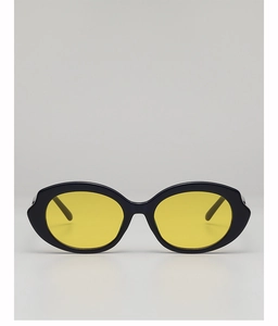 Close-up of retro oval sunglasses with black frames and vibrant yellow lenses