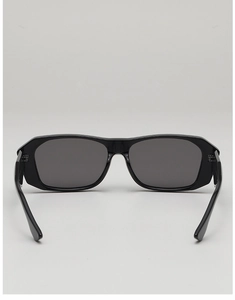 Detail view of the black square sunglasses showing the metal hinges and temple structure