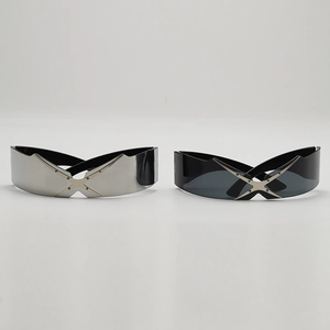 Close-up of futuristic Y2K wrap sunglasses with distinctive metal cross bridge detail