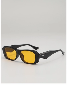 Detail view of vintage square sunglasses with thick black frames and yellow lenses