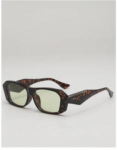 Detail view of vintage tortoise shell sunglasses with wide arms and silver rivets