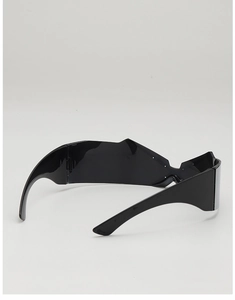 Close-up of futuristic black oversized sunglasses with sleek aerodynamic temple curves