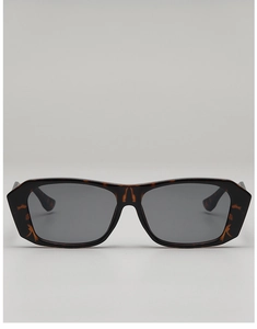 Detail of vintage square sunglasses featuring a tortoise shell frame and dark grey lenses