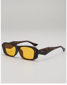 Detail of vintage square tortoiseshell sunglasses with yellow lenses and metal rivets