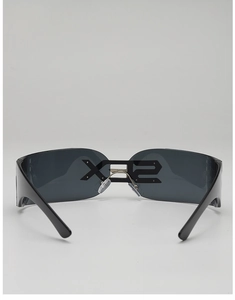 Detailed view of futuristic Y2K wrap-around sunglasses with a sleek black frame