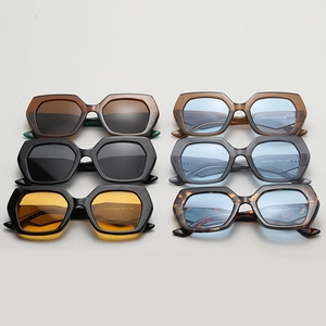 Assorted colors of chunky oversized hexagonal sunglasses in a flat lay view