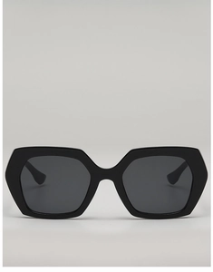Front view of stylish oversized hexagonal sunglasses with matte black frames and dark lenses