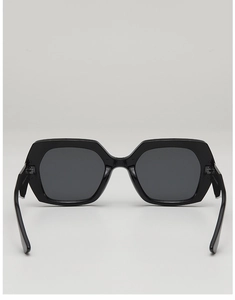 Detail view of bold black square frame sunglasses with dark lenses and durable temples