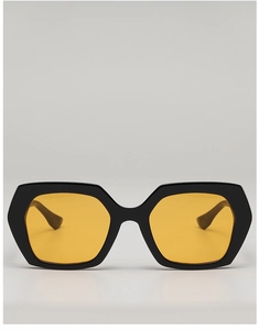 Detailed view of bold black hexagonal sunglasses featuring vibrant yellow tinted lenses