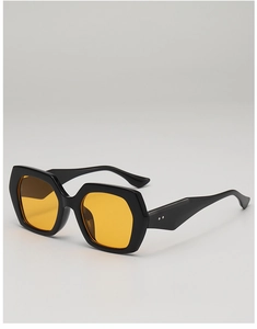 Detail of trendy thick black hexagonal sunglasses with vibrant orange tinted lenses