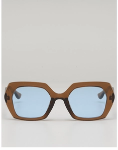 Detailed view of hexagonal brown frames with light blue tinted lenses for travel