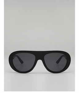 Close-up of modern black oversized flat top aviator sunglasses with integrated frame