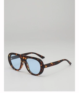 Detail of tortoise shell frame and transparent blue lenses on pilot sunglasses