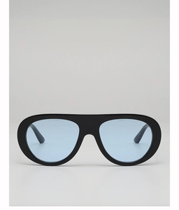 Close-up of thick black frame sunglasses with transparent light blue lenses in a macro view